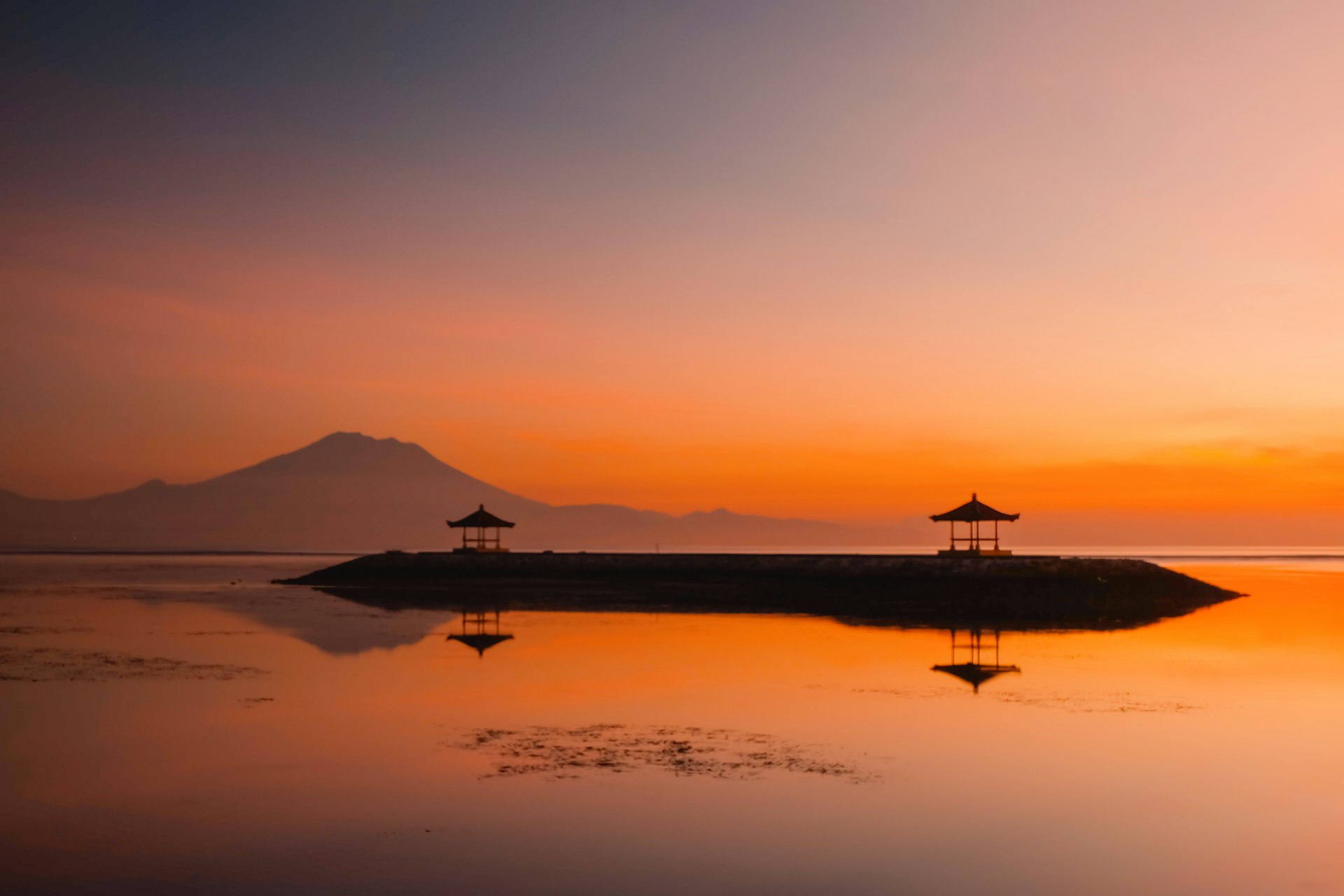 Sanur beach at sunset with traditional shrine pavilions, Bali